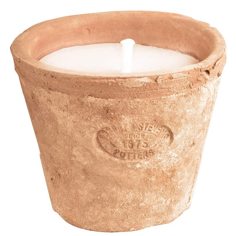 A candle nestled within the Aged Terracotta Pot showcases visible embossed text and a natural, textured surface, bringing rustic charm to any insect-free outdoor gatherings.