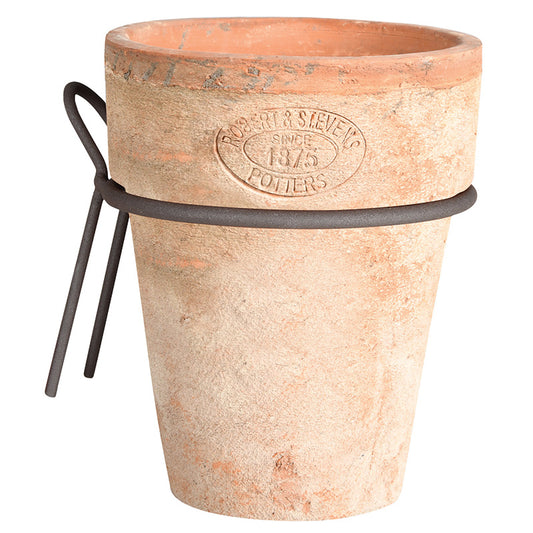 Enhance your Tuscan-themed patio with the Aged Terracotta Long Tom Pot featuring an embossed design that reads "Robert & Stevens, Potters, Since 1875" and a metal wire for wall hanging. This rustic pot, with its charming light brown hue, is available for local pick-up.
