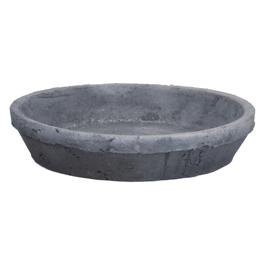 The Aged Terracotta Round Saucer in Charcoal, featuring a round, shallow design with a smooth surface and slightly rough edges, exudes Rustic Tuscan-themed charm. Displayed against a white background, it's ideal for introducing timeless elegance to your patio garden.